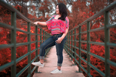 Full length of woman standing on footbridge