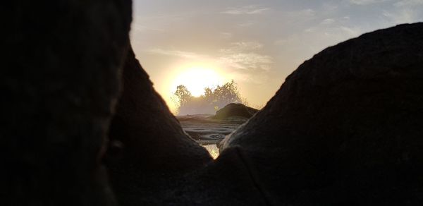 Scenic view of silhouette mountains against sky during sunset