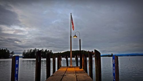 Flag by sea against sky