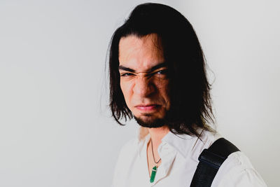 Portrait of young man against white background