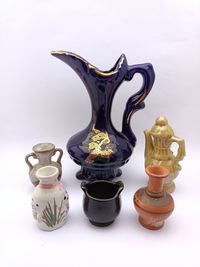 Variation of mini ceramic teapot and mug isolated on white background