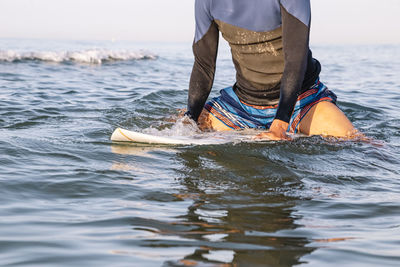 Low section of man in sea