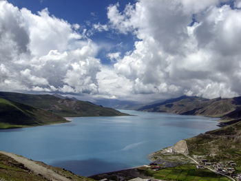 Scenic view of sea and mountains against sky