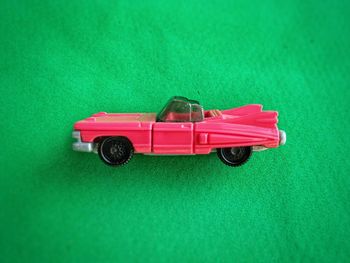 Close-up of toy car against green background