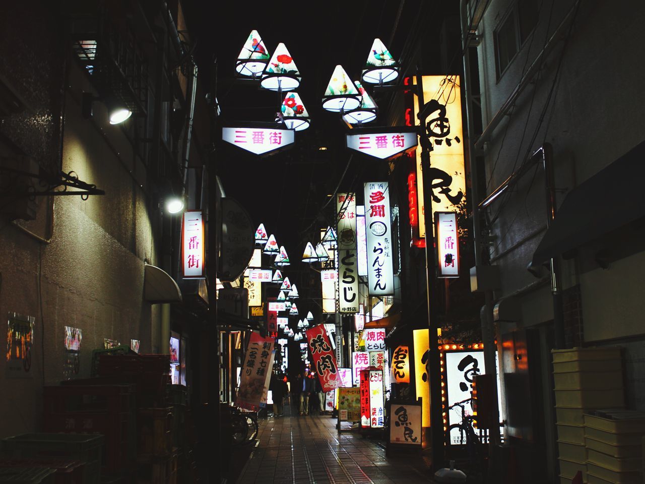 ILLUMINATED LANTERNS HANGING AT STORE