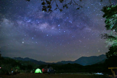 Scenic view of mountains against sky at night