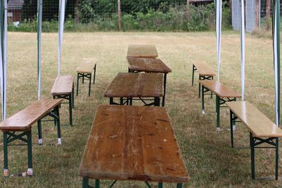 Empty chairs and table in park