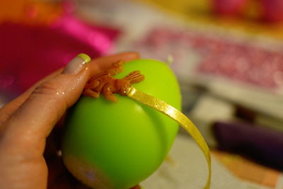 Cropped image of woman hand decorating easter egg