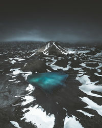 Aerial view of sea and snowcapped mountains against sky