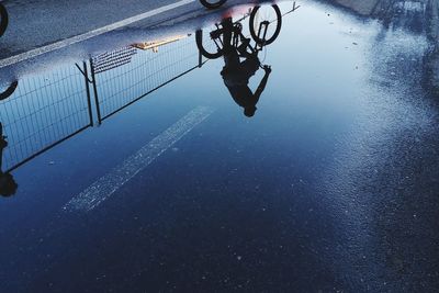 Reflection of man on puddle
