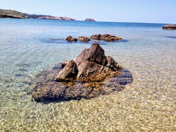 Rocks on beach against sky