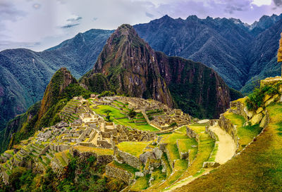 Scenic view of mountains against cloudy sky