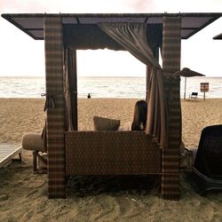 Chairs on beach against sky