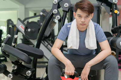 Portrait of man sitting in gym