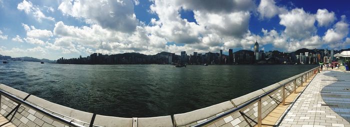 Panoramic view of city against cloudy sky