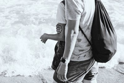 Rear view of man standing on beach