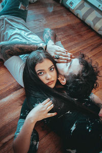 High angle portrait of young woman on floor