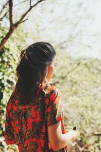 Midsection of woman against tree