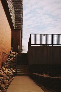 Staircase in city against sky