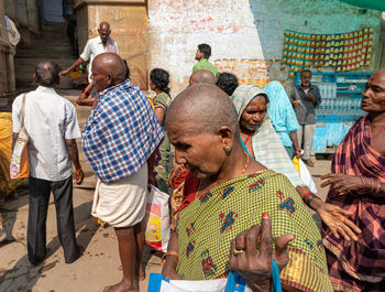 Group of people at market stall in city