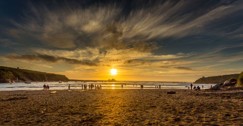 Scenic view of beach against sky during sunset