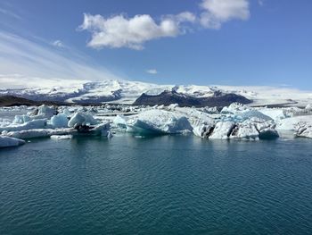 Landscape of glacier lagoon with floating iceberg