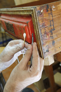 Midsection of person working in wood