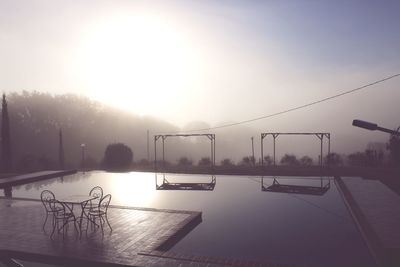 Scenic view of swimming pool against sky during sunset