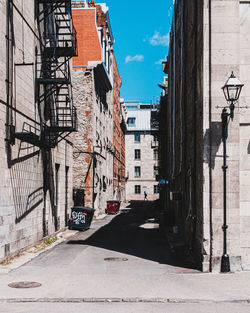 Street amidst buildings against sky in city