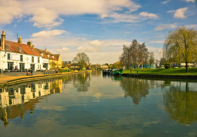 View of buildings in lake against cloudy sky