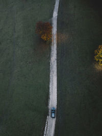 High angle view of road amidst trees on field