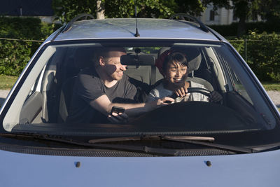 Man teaching woman to drive