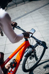 Bicycle courier using smartphone on handlebar