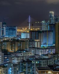 Illuminated cityscape against sky at night