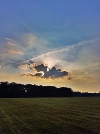 Scenic view of field against sky during sunset
