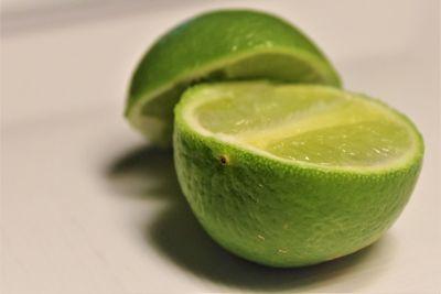 Close-up of green lime on table