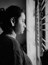 Portrait of young man looking away at home