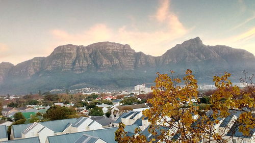 Scenic view of mountains and buildings against sky