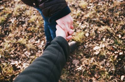 Cropped image of people holding hands