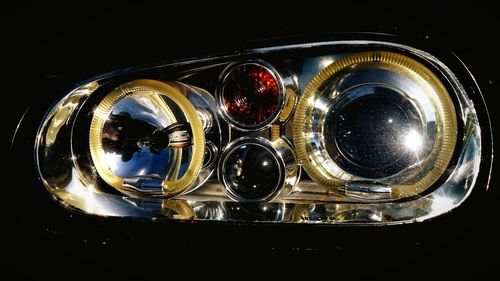 Close-up of light bulb over black background