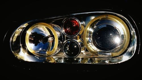 Close-up of light bulb over black background