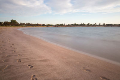 Scenic view of beach against sky during sunset