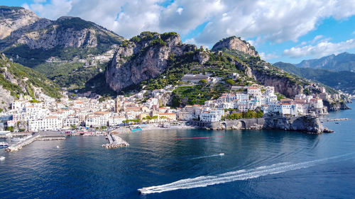 High angle view of townscape by sea against sky