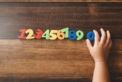 Low section of person with toys on table