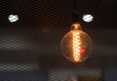 Low angle view of illuminated light bulb