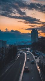 Traffic on road at sunset