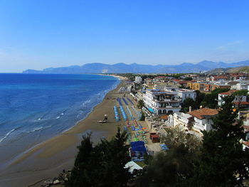 High angle view of sea and cityscape against sky