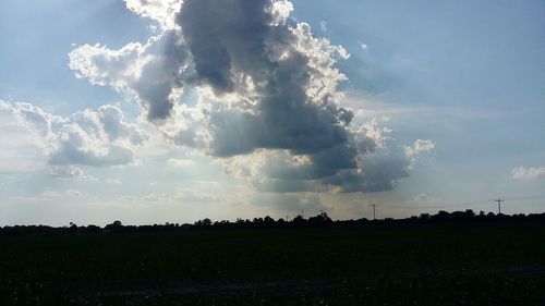 Scenic view of silhouette field against sky