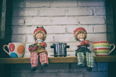 Full length of man sitting with toy on table