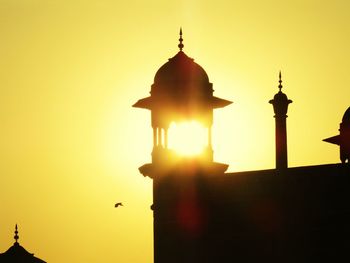 Silhouette temple against sky during sunset